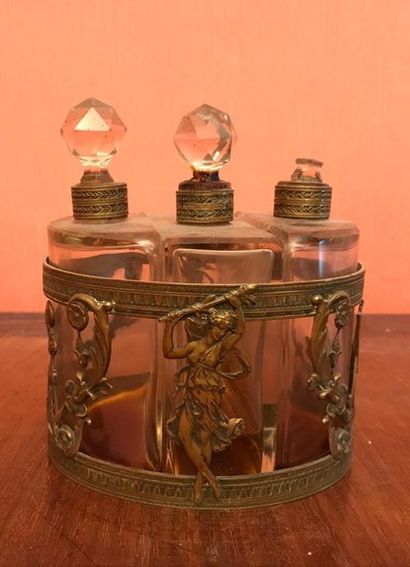 null *Set of three glass perfume bottles in an Empire-style openwork brass frame...