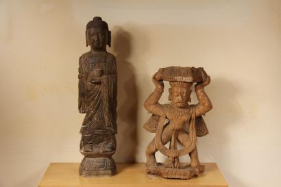 null Two sculptures in stone and wood representing standing Buddha and a figure holding...