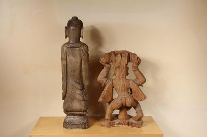 null Two sculptures in stone and wood representing standing Buddha and a figure holding...