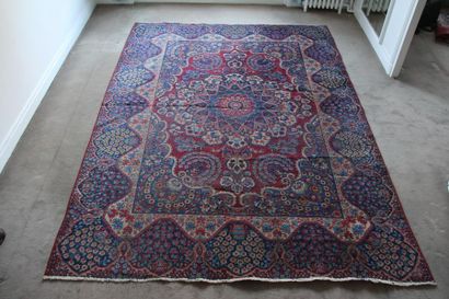 null *Wool carpet with flower decoration in the center on a purple background and...