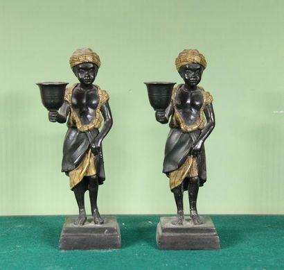 null Pair of polychrome metal candleholders representing young blacks
H: 22 cm. ...