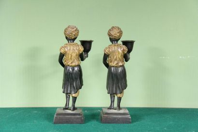 null Pair of polychrome metal candleholders representing young blacks
H: 22 cm. ...