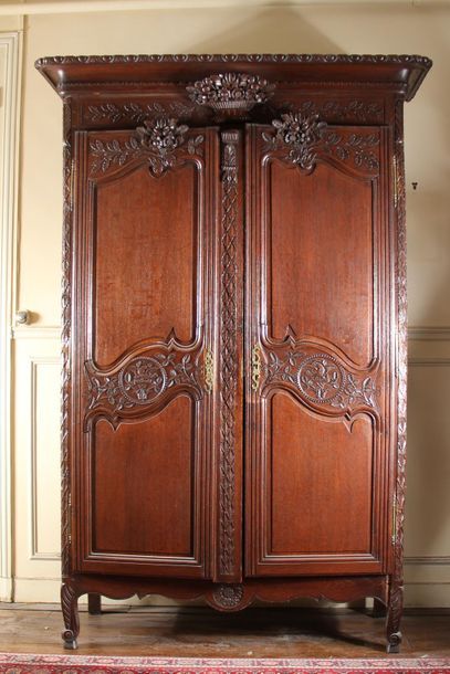 null Moulded and carved natural wood cupboard with a flower basket pediment, Normandy...