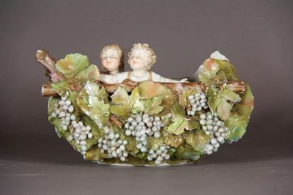 null Oval vase in polychrome porcelain with relief decoration of vine branches and...