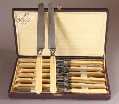 null Eighteen table knives and a carving set, carved ivory handles, silver plated...