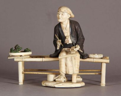 null Okimono in wood and ivory, representing a scholar writing notes on a miniature...