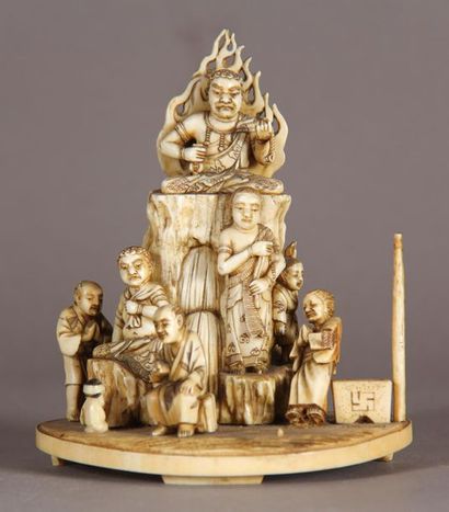 null Okimono in ivory, representing a scene of devotion before the deity Fudomiyo....
