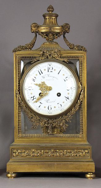 null Cage clock in chased and gilded bronze, topped by an urn decorated with ram's...