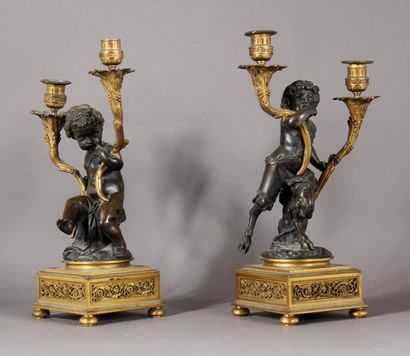 null Pair of small candelabra in gilt bronze and bronze with brown patina, representing...