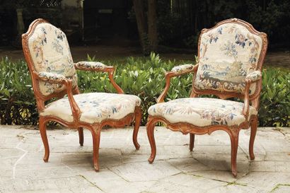 null Pair of armchairs in moulded and sculpted beech wood, the shouldered backrest...