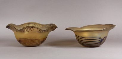 null Contemporary
work Two bowls with an animated border in yellow iridescent glass...