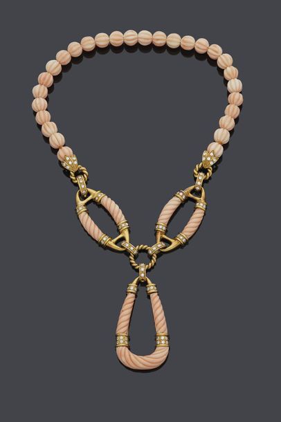 null NECKLACE made up of a row of gadrooned angel skin coral beads, centred on two...