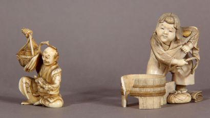 null Set of two ivory okimono, representing a sitting peasant holding a bird, and...