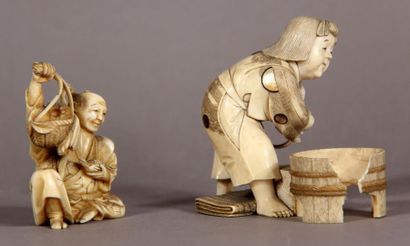 null Set of two ivory okimono, representing a sitting peasant holding a bird, and...