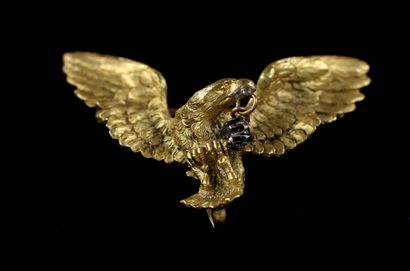 null 18k yellow gold brooch in the shape of an eagle holding a white stone in its...