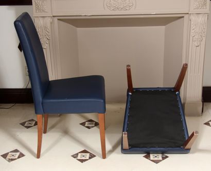null Pair of high-backed chairs in blue grained skai, tapered legs and stained wood...