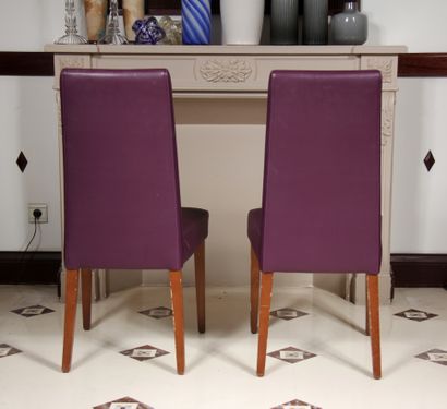 null Pair of high-backed chairs and a pouffe in mauve grained skai, tapered and sabre-shaped...