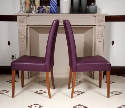 null Four high-backed chairs and a pouffe in mauve grained skai, tapered and sabre-shaped...