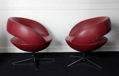 null Five turning armchairs in burgundy grained leather with openwork backrest, cruciform...