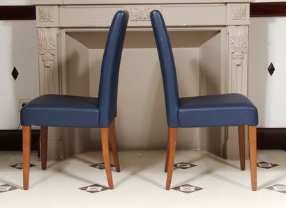 null Pair of high-backed chairs in blue grained skai, tapered legs and stained wood...