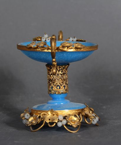 null A blue opaline glass pedestal bowl with brass mount and handles decorated with...