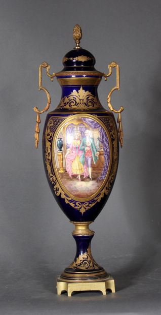 null A blue enamelled baluster vase with two handles on a pedestal decorated with...