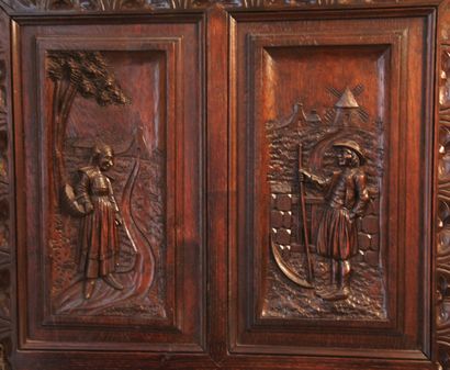 null Jam cupboard in natural wood carved with Breton characters, opening with a ventail...