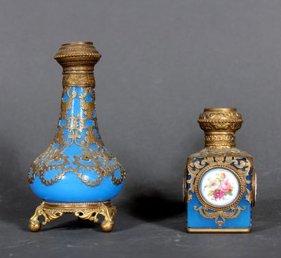 null Two bottles, one cubic and the other baluster, in blue opaline glass with openwork...