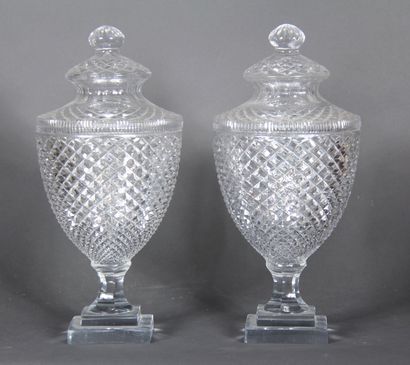 null A pair of covered ovoid vases with a stepped base made of diamond-cut glass.

H...