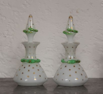 null A pair of white and green opaline glass bottles with gold stars and snakes in...