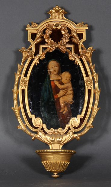 null A gilt bronze stoup on a natural wood base decorated with a copy of the Virgin...