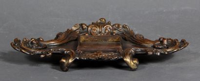 null Four-legged inkwell stand in brown patinated metal with acanthus leaves in relief.

H...