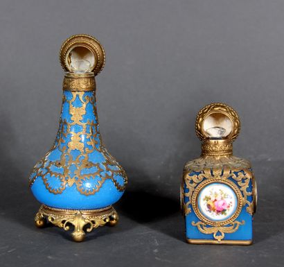 null Two bottles, one cubic and the other baluster, in blue opaline glass with openwork...