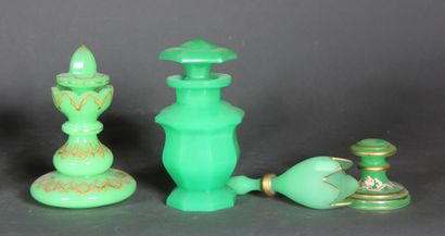 null A green opaline lot including covered flasks and vases, some with white and...