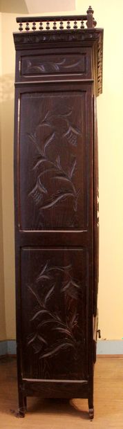 null Jam cupboard in natural wood carved with Breton characters, opening with a ventail...