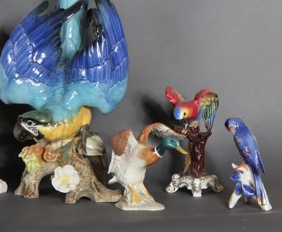 null Set of eight polychrome porcelain statuettes representing parrots and ducks.

H...