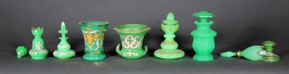 null A green opaline lot including covered flasks and vases, some with white and...