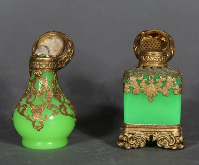 null Two cubic and baluster bottles in green opaline glass, openwork brass mountings,...