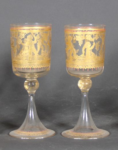 null A transparent and gilded glass lot with white painted scroll or gilded scene...