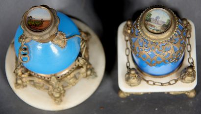null Two blue opaline glass perfume bottles, brass frame. 

Stoppers decorated with...