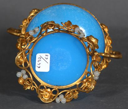 null A blue opaline glass pedestal bowl with brass mount and handles decorated with...