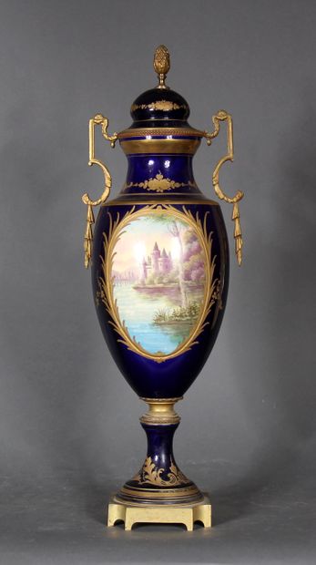 null A blue enamelled baluster vase with two handles on a pedestal decorated with...
