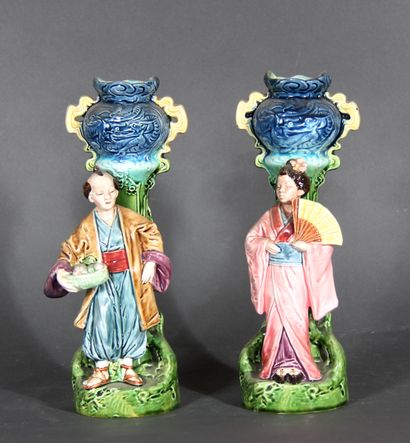 null A pair of polychrome porcelain soliflore vases decorated with Chinese in front...