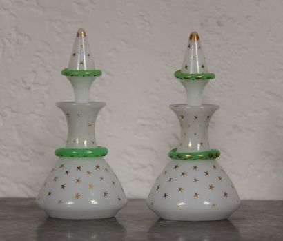 null A pair of white and green opaline glass bottles with gold stars and snakes in...
