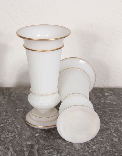 null A pair of fluted vases on a pedestal in white opaline glass with gold edging.

H...