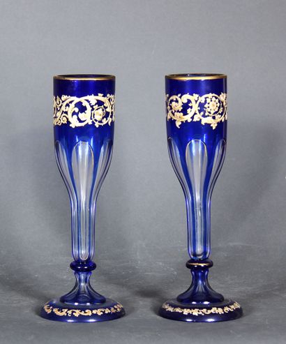 null A pair of transparent and blue overlay glass tulip vases on a pedestal with...