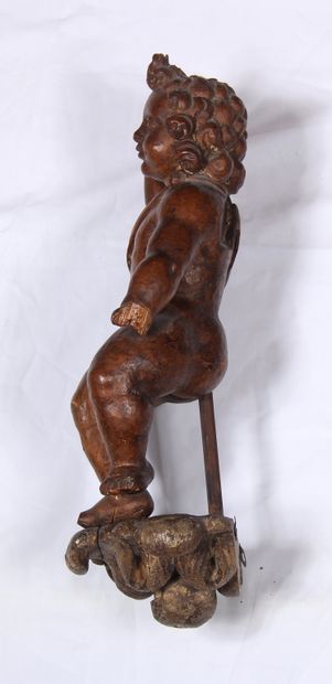 null A fruitwood sculpture representing an angel with his right arm stretched towards...