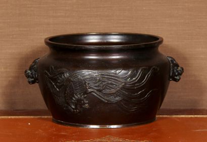 null A patinated bronze cup with two dragon handles, decorated in relief with a phoenix

H...