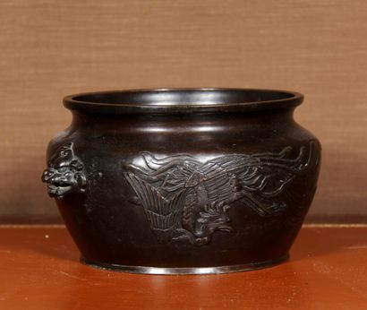 null A patinated bronze cup with two dragon handles, decorated in relief with a phoenix

H...