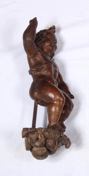 null A fruitwood sculpture representing an angel with his right arm stretched towards...